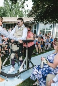 Man walks down wedding aisle with Second Step Gait Harness System